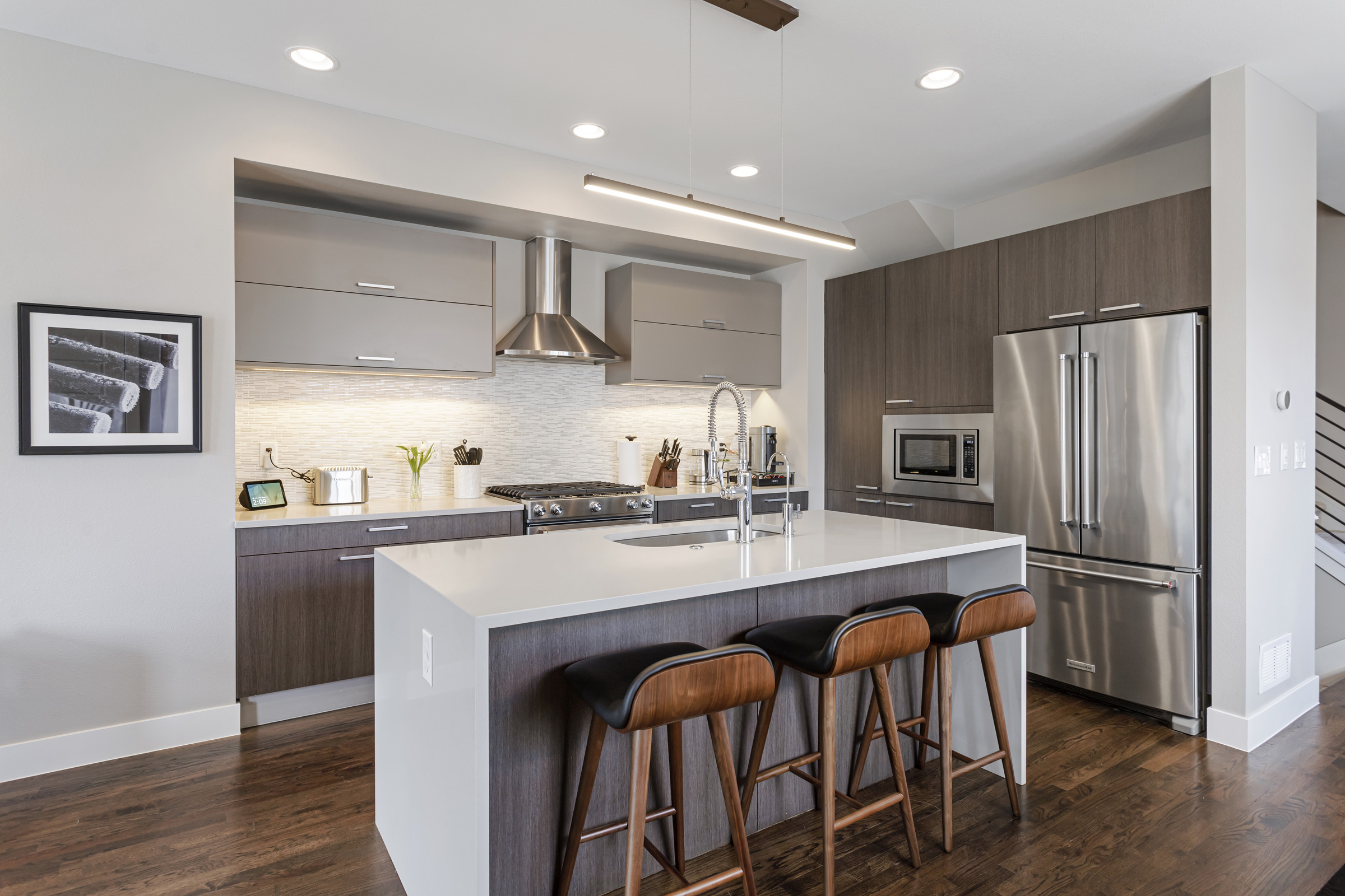 Contemporary kitchen with dark cabinetry